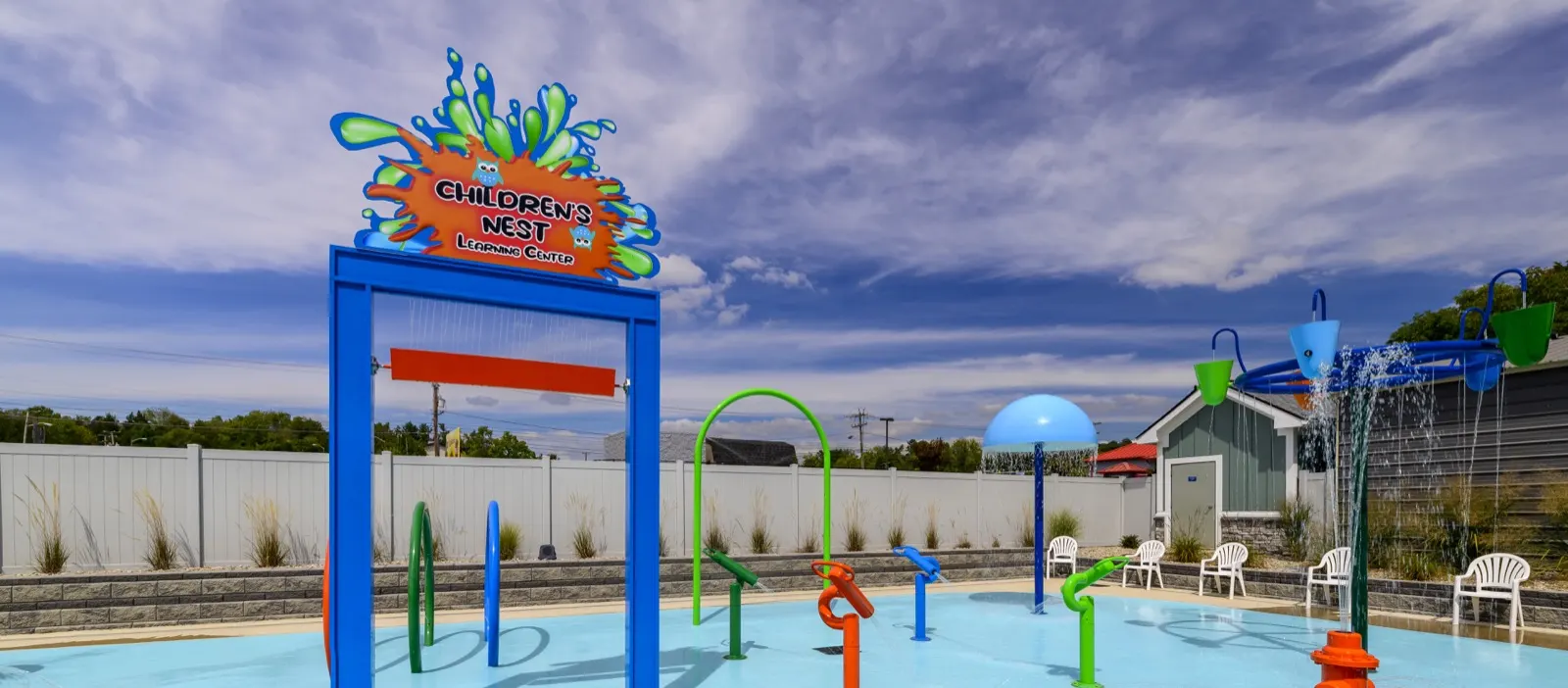 Childcare center splash pad with rubber surfacing and low play features