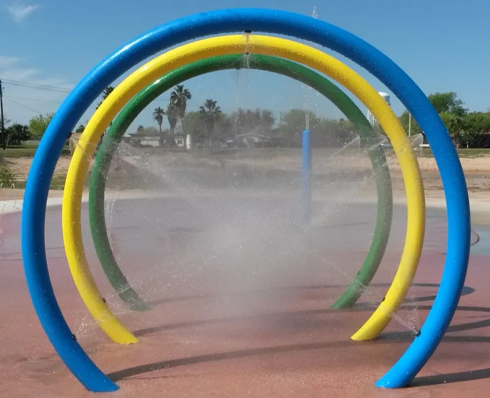 Blue, green and yellow water loop arches spraying mist